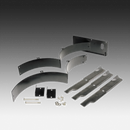 The Husqvarna Mulching Kit includes two metal mulching blades, a black plastic chute cover, metal pins, and mounting hardware to help ZTR Zero Turn mowers recycle clippings and boost lawn nutrients.