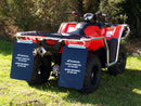 A red Ventura Honda TRX 520 FM1, FM2, FE2 ATV with large tires and a silver metal bumper with bull-bars is parked on a paved road beside green grass and bushes.