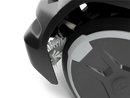Close-up of a Husqvarna Active wheel brush refill kit attached to a CEORA™ 544/546 EPOS robotic mower wheel, with a white cleaning brush beside the tire, against a black background.