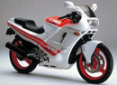 The EVO-12 Bike-Pack Kit by Ventura features a black bike-pack with a gray and orange stripe labeled 'EVO-12 Pack,' an essential Evo-Rack for your Honda CBR 400 R Aero (1987)'s rear, and a versatile L-Bracket with screws and components for easy installation.