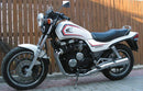 Image showcasing the Ventura EVO-12 Bike-Pack Kit with the adjustable EVO-Rack mounted on a Honda CBX 650 ED, an EVO-12 pack, and a versatile L-bracket complete with screws for secure assembly.