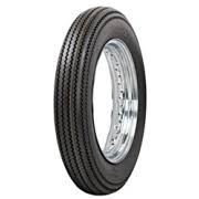 A black Avon Vintage and Classic Tire by Avon Tyres with a shiny silver rim shows a classic tread of thin parallel grooves on its circumference, set against a plain white background.