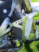 Close-up of the Radiator Frame by Emperor Racing, featuring metal and plastic components with hoses and a side tank. The metal sports an "Emperor Racing" logo.
