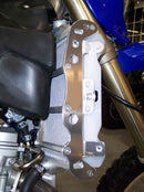 Close-up of the Radiator Frame by Emperor Racing, featuring metal and plastic components with hoses and a side tank. The metal sports an "Emperor Racing" logo.