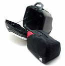 Two black Ventura PANNIER BIKE-PACK KIT bags with red accents and handles are side by side, one slightly in front. These sleek, rectangular motorcycle luggage solutions perfectly fit with Ventura Pannier Frames for an adventurous ride.