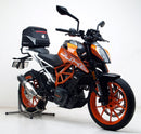 The EVO-12 Bike-Pack Kit image features a sleek black storage bag labeled "EVO-12 Pack," the versatile "Adjustable Pack-Rack" rear rack, and an "L-Bracket" with screws, perfect for mounting on the KTM 390 Duke (17 ->) by Ventura for efficient bike storage.