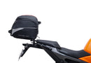 Image showing a Ventura EVO-12 Bike-Pack Kit for KTM 990 Duke (24 - >) with three components: EVO-12 pack bag, Evo-Rack mounted on the motorcycle, and L-brackets with screws. Generic image shown.