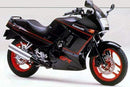 Image of a Ventura EVO-12 Bike-Pack Kit showcasing a sleek black EVO-12 pack with a striking red stripe. Includes an Evo-Rack for Kawasaki ZZR 250 and an L-bracket with screws; each component is displayed separately and clearly labeled.