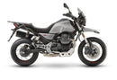 Image featuring the Ventura EVO-12 Bike-Pack Kit: a sleek black EVO-12 pack with an orange stripe, the EVO-Rack securely mounted on a Moto Guzzi 850 V85 TT (19 - >) bike, and an L-Bracket set with screws for excellent pannier support.