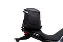 The Ventura EVO-12 Bike-Pack Kit for Moto Guzzi V100, V100S Mandello (22 - >) includes a black EVO-12 pack, a black Evo-Rack or Adjustable Pack-Rack mounted on the motorcycle, and an image of a labeled L-bracket with hardware.