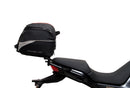 The Ventura EVO-12 Bike-Pack Kit for Moto Guzzi V100, V100S Mandello (22 - >) includes a black EVO-12 pack, a black Evo-Rack or Adjustable Pack-Rack mounted on the motorcycle, and an image of a labeled L-bracket with hardware.