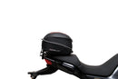 The Ventura EVO-12 Bike-Pack Kit for Moto Guzzi V100, V100S Mandello (22 - >) includes a black EVO-12 pack, a black Evo-Rack or Adjustable Pack-Rack mounted on the motorcycle, and an image of a labeled L-bracket with hardware.