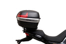 The Ventura EVO-12 Bike-Pack Kit for Moto Guzzi V100, V100S Mandello (22 - >) includes a black EVO-12 pack, a black Evo-Rack or Adjustable Pack-Rack mounted on the motorcycle, and an image of a labeled L-bracket with hardware.
