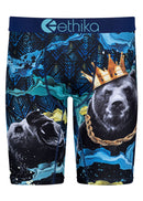 A pair of Ethika Kingdom Staple men's boxer briefs from Ethika, featuring two bears—one roaring and the other adorned with a gold crown and chain necklace. The background showcases abstract patterns with blue, black, and yellow swirls. Crafted for ultimate comfort with Staple Fit and a high-quality jacquard waistband.