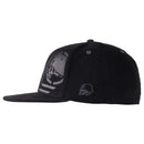 A Metal Mulisha Sketched Flex Hat in black, featuring a flat bill and an embroidered monochrome skull wearing a helmet on the side. The front showcases an embroidered stylized dodo bird within a circular frame, giving it a distinctive edgy look reminiscent of the Metal Mulisha brand.