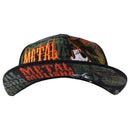 The Metal Mulisha Bunker Flex Hat is a black flat-brim cap with a multicolored camouflage design on the front panel and brim, featuring an embroidered skull icon in orange thread on the side panel, reflecting Metal Mulisha's signature style.