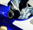 Close-up of an Oggy Knobbs Yamaha Frame Slider mounted on a bike with blue and white fairing. The slider is black with a circular end and metallic base, attached to the frame for protection in case of a fall.