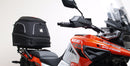 Ventura's EVO-12 Bike-Pack Kit image features a striking black EVO-12 pack with vibrant orange accents, an EVO-Rack gracefully fitted on a Suzuki DL 1050 V-Strom XT bike, and an L-Bracket with screws. The Adjustable Pack-Rack is designed to enhance your biking experience.