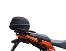 Ventura's EVO-12 Bike-Pack Kit image features a striking black EVO-12 pack with vibrant orange accents, an EVO-Rack gracefully fitted on a Suzuki DL 1050 V-Strom XT bike, and an L-Bracket with screws. The Adjustable Pack-Rack is designed to enhance your biking experience.