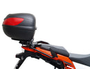 Ventura's EVO-12 Bike-Pack Kit image features a striking black EVO-12 pack with vibrant orange accents, an EVO-Rack gracefully fitted on a Suzuki DL 1050 V-Strom XT bike, and an L-Bracket with screws. The Adjustable Pack-Rack is designed to enhance your biking experience.