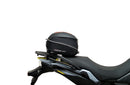 Collage of EVO-12 Bike-Pack Kit components by Ventura for Suzuki DL 800 DE V-Strom (23 - >). Includes black EVO-12 pack with orange stripe, Evo-Rack on the bike rear, L-Bracket with image label and screws. Consider the Top-Box Rack for extra storage on your adventures.
