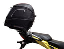 Image showing components of the Ventura EVO-12 Bike-Pack Kit for Suzuki V-Strom 250SX (23->): a black EVO-12 pack, Evo-Rack Adjustable Pack-Rack on a motorcycle, and labeled L-brackets with screws. Each item is individually labeled.