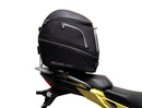 Image showing components of the Ventura EVO-12 Bike-Pack Kit for Suzuki V-Strom 250SX (23->): a black EVO-12 pack, Evo-Rack Adjustable Pack-Rack on a motorcycle, and labeled L-brackets with screws. Each item is individually labeled.