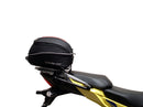 Image showing components of the Ventura EVO-12 Bike-Pack Kit for Suzuki V-Strom 250SX (23->): a black EVO-12 pack, Evo-Rack Adjustable Pack-Rack on a motorcycle, and labeled L-brackets with screws. Each item is individually labeled.