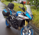 Image showing the Ventura EVO-12 Bike-Pack Kit for Suzuki GSX-S 1000 GX/GX+ (24->), with a black EVO-12 pack, Evo-Rack Top-Box Rack mounted on the motorcycle, and generic L-bracket kit with metal bars and screws, all clearly labeled.