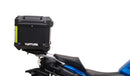 Image showing the Ventura EVO-12 Bike-Pack Kit for Suzuki GSX-S 1000 GX/GX+ (24->), with a black EVO-12 pack, Evo-Rack Top-Box Rack mounted on the motorcycle, and generic L-bracket kit with metal bars and screws, all clearly labeled.