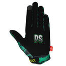 The DANIEL SANDOVAL - SANDMAN GLOVE by FIST features a bold green, black, and gray graphic with jagged shapes and teeth. "FIST" is printed in yellow on the fingers, plus a red "FIST" tag at the wrist.