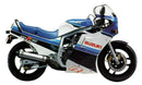 The Ventura EVO-12 Bike-Pack Kit for Suzuki GSXR 750 F, G includes a black EVO-12 pack, metal Adjustable Pack-Rack, and L-Bracket with screws and hardware—all clearly labeled for easy identification.