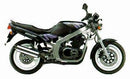 Image showing the Ventura EVO-12 bike pack, Evo-Rack mounted on a Suzuki GS 500 EK - EN (89 >), and a generic L-bracket with screws. Each item is labeled as part of the Adjustable Pack-Rack system kit.