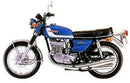 Image showing three components for the Ventura Suzuki GT 380 J, K, L (72-74): a black EVO-12 pack, a metal Evo-Rack mounted on a motorcycle, and an L-bracket with screws.