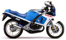The Ventura EVO-12 Bike-Pack Kit for Suzuki RG 250 WG/WH includes a black EVO-12 pack, an EVO-Rack (Top-Box Rack), labeled black L-Brackets with mounting hardware, and is also compatible with the Adjustable Pack-Rack system.