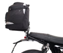 Image shows three labeled Ventura items for the Triumph Speed Twin 1200 (19->): an EVO-12 Pack (compact black bag), Evo-Rack adjustable rack mounted on the motorcycle, and a generic L-Bracket with bolts.