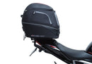 Image showing the Ventura EVO-12 Bike-Pack Kit for Triumph Speed Triple 1200 RS, RR (21 ->), featuring a black EVO-12 Pack tail bag, Evo-Rack Top-Box Rack, and an L-Bracket with screws and mounting hardware.