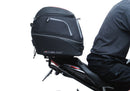 Image showing the Ventura EVO-12 Bike-Pack Kit for Triumph Speed Triple 1200 RS, RR (21 ->), featuring a black EVO-12 Pack tail bag, Evo-Rack Top-Box Rack, and an L-Bracket with screws and mounting hardware.