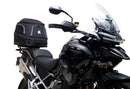 Ventura EVO-12 Bike-Pack Kit for Triumph Tiger 1200GT/Pro/Explorer (22->) includes a black EVO-12 pack, Adjustable Pack-Rack (EVO-RACK) mounted on the bike, and a labeled L-Bracket with screws.