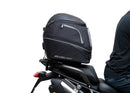 Ventura EVO-12 Bike-Pack Kit for Triumph Tiger 1200GT/Pro/Explorer (22->) includes a black EVO-12 pack, Adjustable Pack-Rack (EVO-RACK) mounted on the bike, and a labeled L-Bracket with screws.