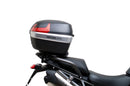 Ventura EVO-12 Bike-Pack Kit for Triumph Tiger 1200GT/Pro/Explorer (22->) includes a black EVO-12 pack, Adjustable Pack-Rack (EVO-RACK) mounted on the bike, and a labeled L-Bracket with screws.
