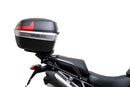 Ventura EVO-12 Bike-Pack Kit for Triumph Tiger 1200GT/Pro/Explorer (22->) includes a black EVO-12 pack, Adjustable Pack-Rack (EVO-RACK) mounted on the bike, and a labeled L-Bracket with screws.