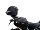 Ventura EVO-12 Bike-Pack Kit for Triumph Tiger 1200GT/Pro/Explorer (22->) includes a black EVO-12 pack, Adjustable Pack-Rack (EVO-RACK) mounted on the bike, and a labeled L-Bracket with screws.