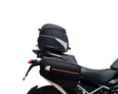 Ventura EVO-12 Bike-Pack Kit for Triumph Tiger 1200GT/Pro/Explorer (22->) includes a black EVO-12 pack, Adjustable Pack-Rack (EVO-RACK) mounted on the bike, and a labeled L-Bracket with screws.