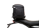 Image showing three components for the Ventura EVO-12 Bike-Pack Kit on a Triumph Scrambler 400X (24->): the EVO-12 pack (black bag), EVO-rack Sport-Rack (metal rack), and L-Bracket with hardware, each labeled with text.