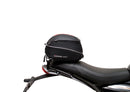 Image showing three components for the Ventura EVO-12 Bike-Pack Kit on a Triumph Scrambler 400X (24->): the EVO-12 pack (black bag), EVO-rack Sport-Rack (metal rack), and L-Bracket with hardware, each labeled with text.
