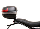 Image showing three components for the Ventura EVO-12 Bike-Pack Kit on a Triumph Scrambler 400X (24->): the EVO-12 pack (black bag), EVO-rack Sport-Rack (metal rack), and L-Bracket with hardware, each labeled with text.