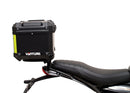 Image showing three components for the Ventura EVO-12 Bike-Pack Kit on a Triumph Scrambler 400X (24->): the EVO-12 pack (black bag), EVO-rack Sport-Rack (metal rack), and L-Bracket with hardware, each labeled with text.