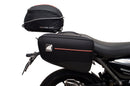 Image showing three components for the Ventura EVO-12 Bike-Pack Kit on a Triumph Scrambler 400X (24->): the EVO-12 pack (black bag), EVO-rack Sport-Rack (metal rack), and L-Bracket with hardware, each labeled with text.