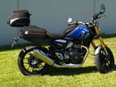 Image showing three components for the Ventura EVO-12 Bike-Pack Kit on a Triumph Scrambler 400X (24->): the EVO-12 pack (black bag), EVO-rack Sport-Rack (metal rack), and L-Bracket with hardware, each labeled with text.